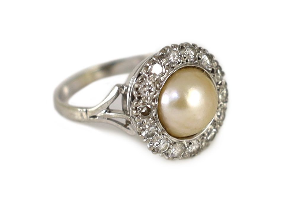 A mid 20th century platinum?, split pearl and diamond set circular cluster ring
